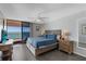 Comfortable bedroom featuring ocean views, wood-look floors, and a ceiling fan at 1340 Gulf Blvd # 16F, Clearwater, FL 33767