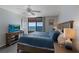 Inviting bedroom with ocean view, ceiling fan, and flat-screen TV at 1340 Gulf Blvd # 16F, Clearwater, FL 33767