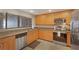 The kitchen features stainless steel appliances, wooden cabinets, and stone countertops at 1340 Gulf Blvd # 16F, Clearwater, FL 33767