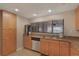 Kitchen boasts wooden cabinets, granite countertops, stainless appliances, and a large window at 1340 Gulf Blvd # 16F, Clearwater, FL 33767