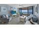 Inviting living room featuring stylish furniture, modern decor, and panoramic views of the ocean from the balcony at 1340 Gulf Blvd # 16F, Clearwater, FL 33767