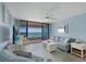 Beautiful living room with blue accents, sliding glass doors to balcony, and breathtaking ocean views at 1340 Gulf Blvd # 16F, Clearwater, FL 33767