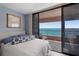 Comfortable main bedroom with balcony access and stunning ocean views, a perfect escape at 1340 Gulf Blvd # 16F, Clearwater, FL 33767