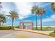 Outdoor grill area with a shelter, palm trees, and ocean view at 1340 Gulf Blvd # 16F, Clearwater, FL 33767