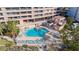 Aerial view of a pool with lounge chairs and a nearby outdoor pavilion at 1340 Gulf Blvd # 16F, Clearwater, FL 33767
