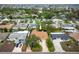 A closer aerial view of a cozy home featuring lush landscaping and a welcoming driveway at 1370 Hill Dr, Largo, FL 33770