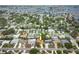 An aerial view showing a neighborhood with houses, landscaped lawns, and access to the bay at 1370 Hill Dr, Largo, FL 33770