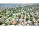 An aerial view of a tranquil neighborhood, featuring houses, green trees, and a waterfront view at 1370 Hill Dr, Largo, FL 33770