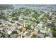 An aerial view of a cozy neighborhood with tree-lined streets and houses near the water at 1370 Hill Dr, Largo, FL 33770