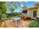 Enjoy outdoor dining in this backyard with seating surrounded by mature landscaping at 1370 Hill Dr, Largo, FL 33770
