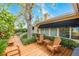 Backyard deck surrounded by lush greenery offers a serene outdoor space at 1370 Hill Dr, Largo, FL 33770