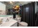 Unique bathroom features decorative wallpaper, a sink, and a shower with modern fixtures at 1370 Hill Dr, Largo, FL 33770