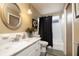 Bathroom featuring a bright vanity with a marble countertop, brushed nickel faucet, and shower/tub combo at 1370 Hill Dr, Largo, FL 33770