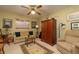 Cozy bedroom with a comfortable sofa, ceiling fan, desk, and a classic armoire at 1370 Hill Dr, Largo, FL 33770
