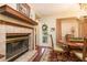 Charming dining room featuring a fireplace, elegant lighting, and access to the backyard at 1370 Hill Dr, Largo, FL 33770