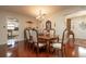 Formal dining room features wood table and chairs, chandelier, and natural light at 1370 Hill Dr, Largo, FL 33770