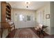 Welcoming foyer with classic rolltop desk, antique bench, and stylish rug at 1370 Hill Dr, Largo, FL 33770
