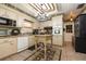 Traditional kitchen features ample cabinetry, tile flooring, a center island and decorative accents at 1370 Hill Dr, Largo, FL 33770