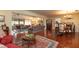 Spacious living room with hardwood floors, fireplace, dining area, and an abundance of natural light at 1370 Hill Dr, Largo, FL 33770