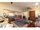 Expansive living room flows into the dining area with hardwood floors and comfortable seating at 1370 Hill Dr, Largo, FL 33770