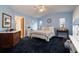 Serene primary bedroom with a vaulted ceiling, comfortable bed, and a connected bathroom at 1370 Hill Dr, Largo, FL 33770