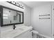 A sleek bathroom that features a new vanity, updated mirror and shower fixtures and a unique tile flooring design at 1586 Linwood Dr, Clearwater, FL 33755