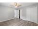 Well-lit bedroom featuring wood-look floors, two closets, and neutral walls, ready for personal touches at 1586 Linwood Dr, Clearwater, FL 33755