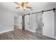 A bedroom that provides ensuite bathroom access with hardwood floors, neutral paint, and lots of natural light at 1586 Linwood Dr, Clearwater, FL 33755