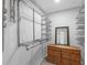 Walk-in closet featuring wood-look floors, built-in adjustable storage system, and a dresser with a mirror at 1586 Linwood Dr, Clearwater, FL 33755