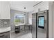 Eat-in kitchen with stainless steel refrigerator, and a sunny view from the adjacent breakfast nook at 1586 Linwood Dr, Clearwater, FL 33755