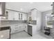 Bright kitchen with white cabinetry, stainless steel appliances, subway tile backsplash, and a modern sink at 1586 Linwood Dr, Clearwater, FL 33755