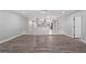 Open-concept living space with modern flooring and sight lines into the adjacent bright, eat-in kitchen with an island at 1586 Linwood Dr, Clearwater, FL 33755