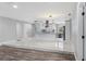 Spacious open-concept living area with wood-look flooring seamlessly connecting to the modern kitchen at 1586 Linwood Dr, Clearwater, FL 33755