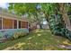 Backyard featuring beautiful landscaping, including mature trees, providing a serene and private outdoor space at 1711 N Highland Ave, Clearwater, FL 33755