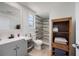 Bright bathroom with gray shower tiles and gray cabinets at 1711 N Highland Ave, Clearwater, FL 33755