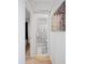 Hallway view to bathroom, features a shower with nautical themed shower curtain and an adjacent bedroom at 1711 N Highland Ave, Clearwater, FL 33755