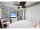 Bedroom with flatscreen TV, double closets, and chair at 1711 N Highland Ave, Clearwater, FL 33755