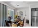 Cozy dining area featuring a round wooden table, decorative accents, and natural light from sliding door at 1711 N Highland Ave, Clearwater, FL 33755