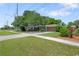 Corner lot home with well-maintained lawn, mature landscaping, and a two-car garage at 1711 N Highland Ave, Clearwater, FL 33755