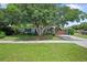 Charming single-story home with blue exterior paint, a well-manicured lawn, mature shade trees, and a two-car garage at 1711 N Highland Ave, Clearwater, FL 33755