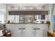 Open-concept kitchen featuring stainless steel appliances, granite countertops, and bar seating at 1711 N Highland Ave, Clearwater, FL 33755