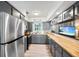 Bright kitchen with stainless steel appliances, light gray cabinets, and butcher block countertops at 1711 N Highland Ave, Clearwater, FL 33755