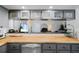Kitchen counter with stainless steel dishwasher and bar counter space with stools at 1711 N Highland Ave, Clearwater, FL 33755