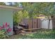 A brown shed provides extra storage in the back of the property with lush green ground cover and an adjacent tree at 1711 N Highland Ave, Clearwater, FL 33755