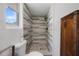 Shower with gray tile and brown cabinet at 1711 N Highland Ave, Clearwater, FL 33755