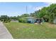 A spacious yard with blue Adirondack chairs centered around a firepit is perfect for outdoor entertaining at 1711 N Highland Ave, Clearwater, FL 33755