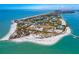 Stunning aerial view of an island community with waterfront homes and clear blue ocean at 18093 Ohara Dr, Port Charlotte, FL 33948