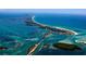 Beautiful aerial view of a coastal community surrounded by clear turquoise water and white sand beaches at 18093 Ohara Dr, Port Charlotte, FL 33948