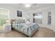 Light filled bedroom featuring a ceiling fan, floral bedding, and a calming wall print at 18093 Ohara Dr, Port Charlotte, FL 33948