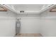 Spacious walk-in closet featuring ample shelving, hanging rods, and an ironing board at 18093 Ohara Dr, Port Charlotte, FL 33948